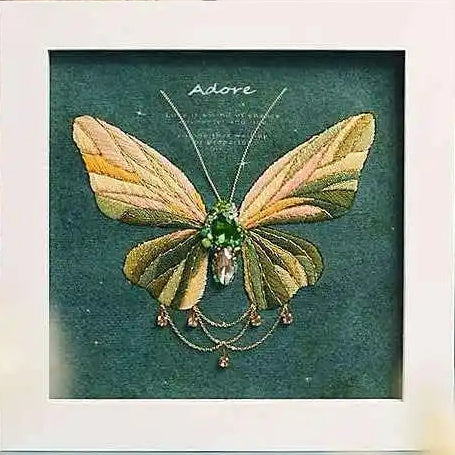 a felt butterfly sewing kit you stitch yourself with a sparkling green zircon center and delicate metal chain details by Butterfly Aura