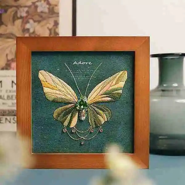 a felt butterfly sewing kit you stitch yourself with a sparkling green zircon center and delicate metal chain details by Butterfly Aura