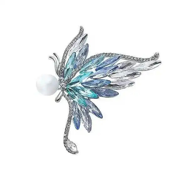 silver butterfly brooch with folded wings set in blue zircon and crystal plus a pearl held like a treasure by Butterfly Aura