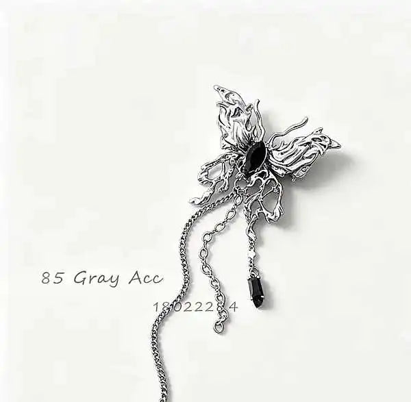 vintage silver tassel brooch with dark stone inlay that moves like jewelry and pins like art for a quietly dramatic finish